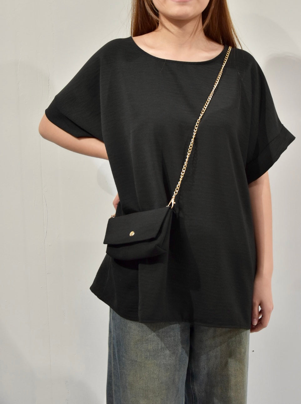 black top with chain bag