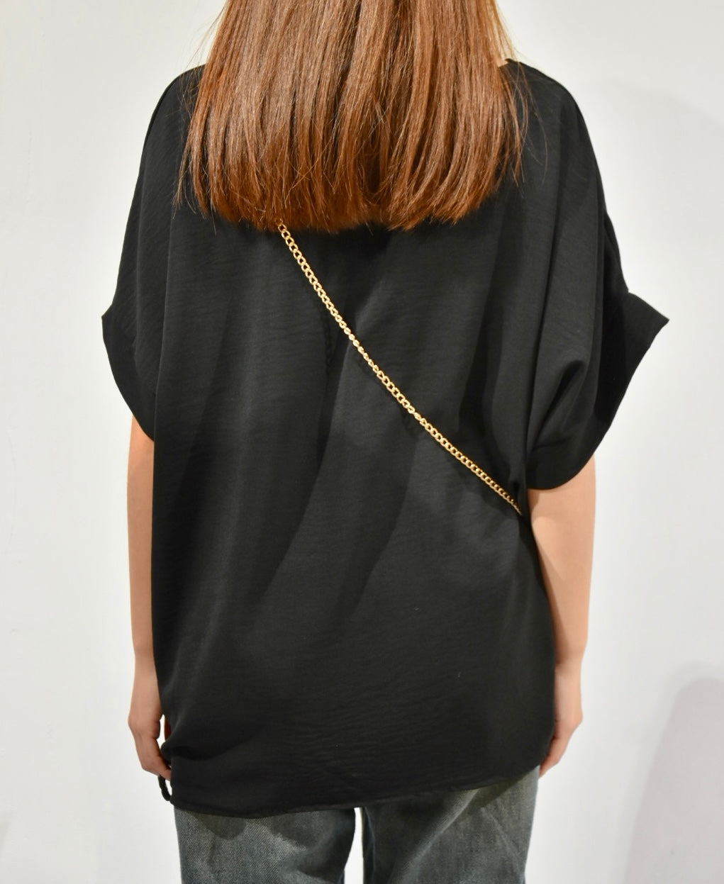 black top with chain bag